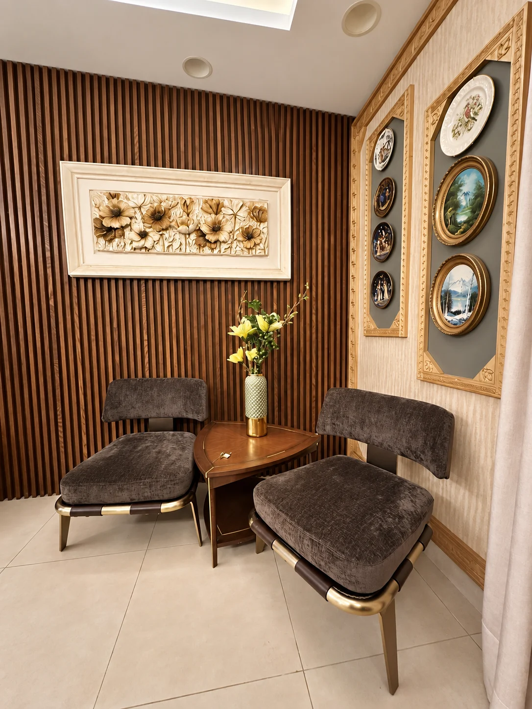 Seating nook with two upholstered chairs, a triangular table and decorative wall plates
